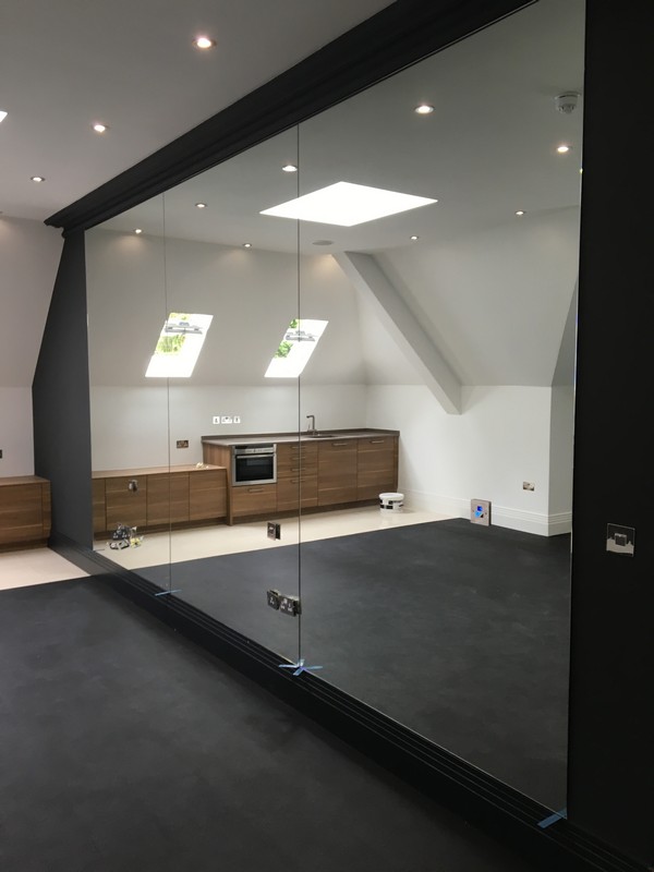 Frameless glass partition in loft conversion by Islington glaziers