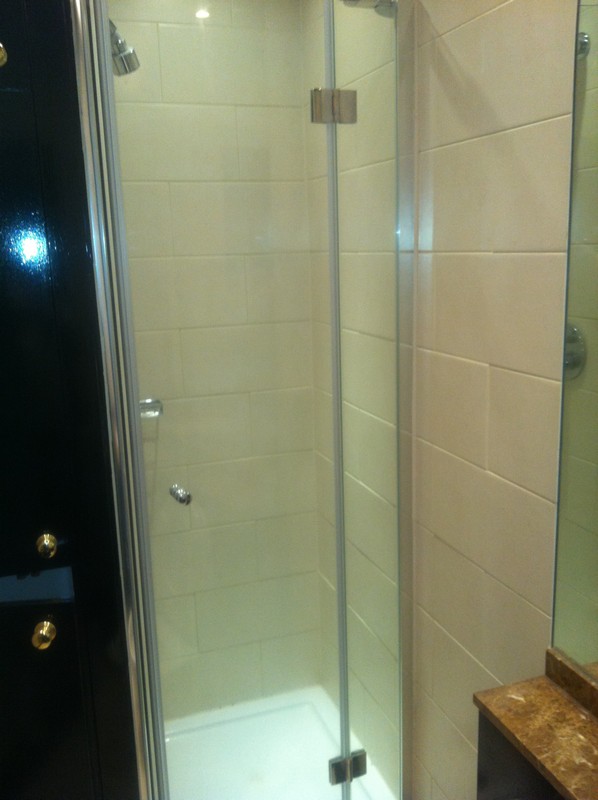Frameless glass shower enclosure with chrome fittings in Islington