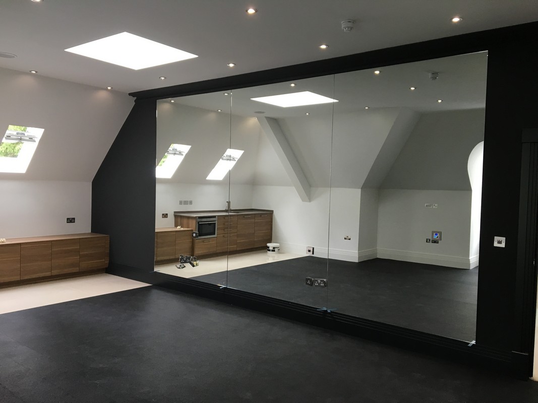 Frameless glass wall dividing loft conversion in Islington