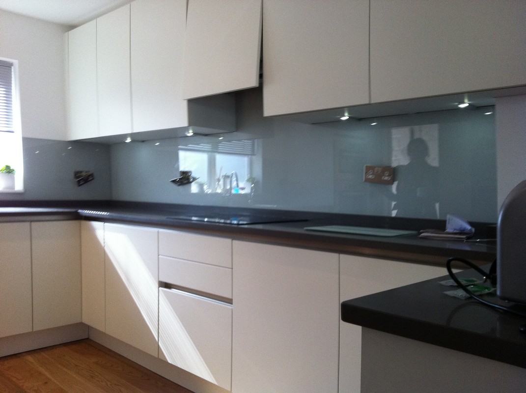 Grey glass kitchen splashback with LED lighting in Islington