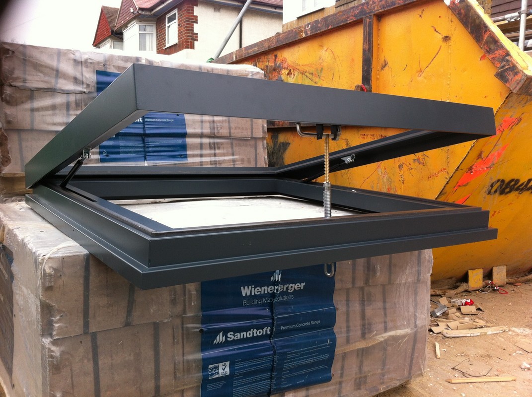 Opening flat roof skylight in anthracite grey installed in Islington