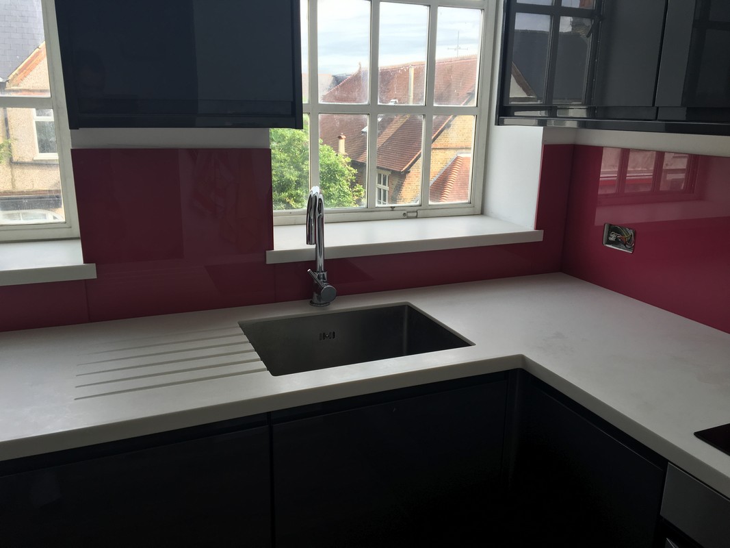 Deep plum coloured glass splashback in modern Islington kitchen