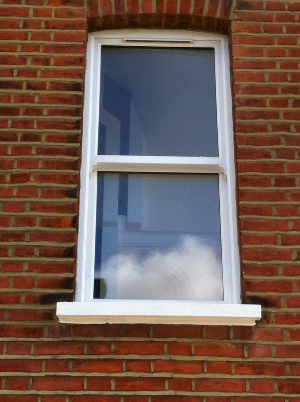 uPVC sash window on Victorian red brick house in Islington